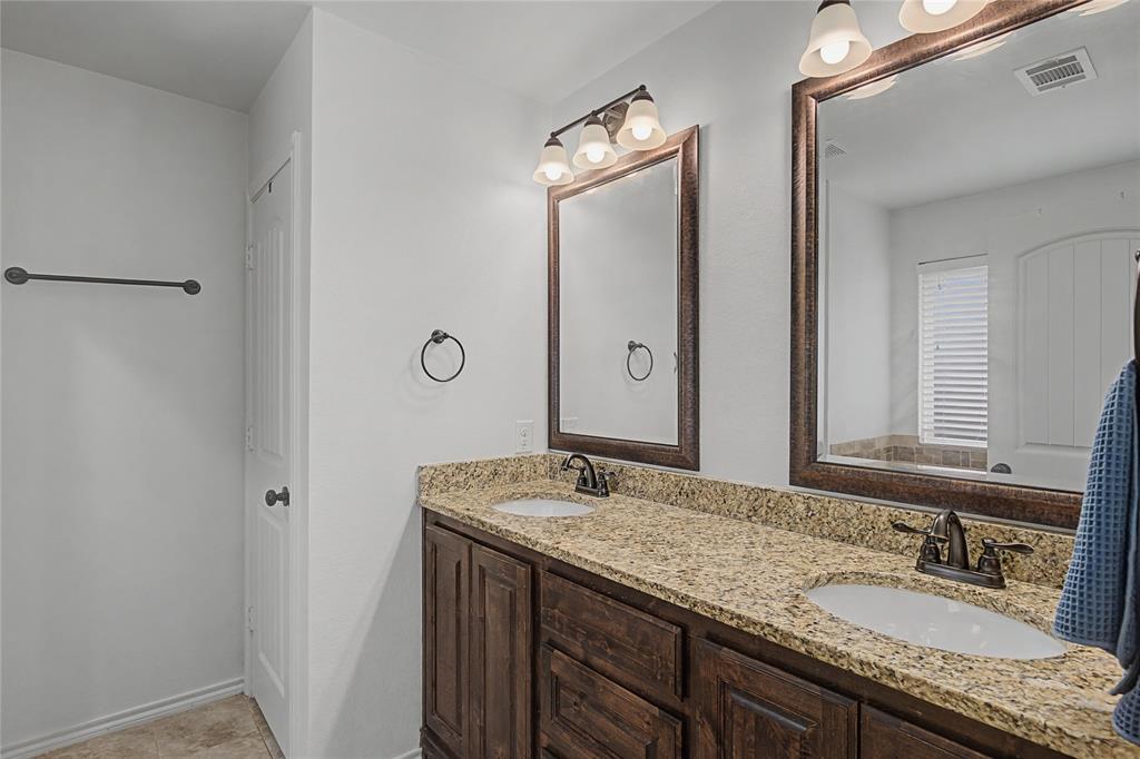 208 Lovers Path Drive Springtown, TX 76082 - Photo 22 of 35 a bathroom with a granite countertop sink and a mirror