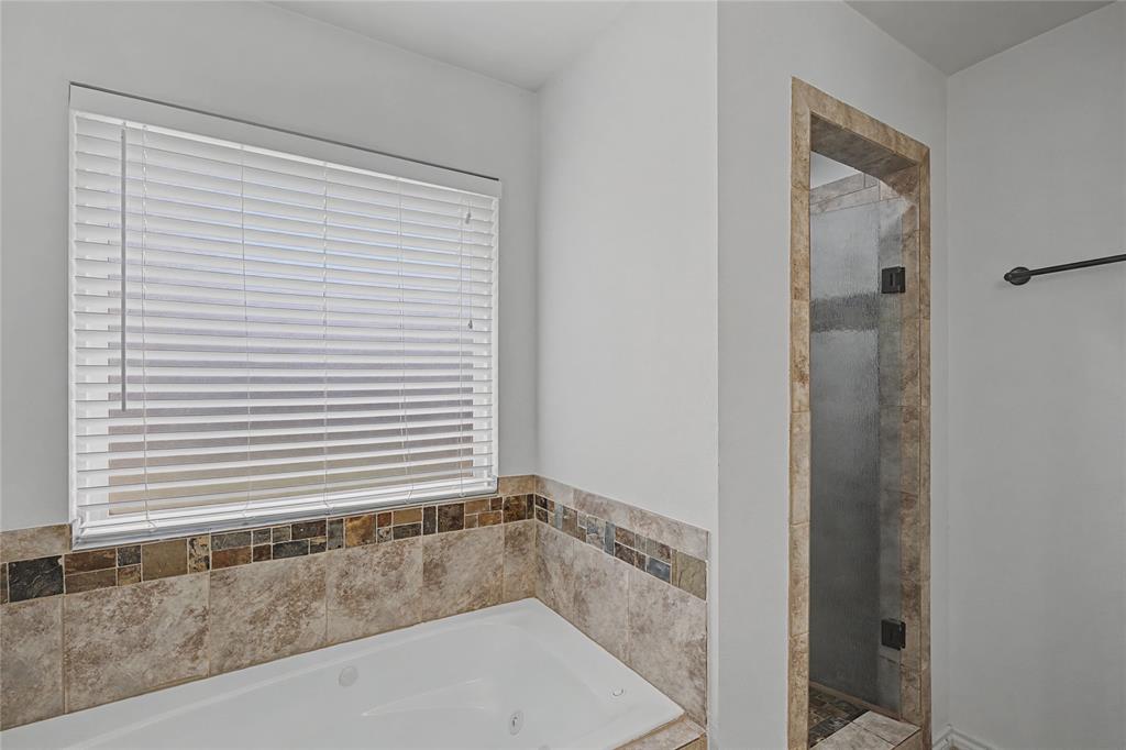 208 Lovers Path Drive Springtown, TX 76082 - Photo 23 of 35 a bathroom with a bathtub and a shower