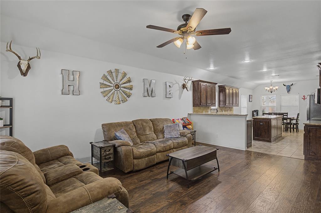 208 Lovers Path Drive Springtown, TX 76082 - Photo 6 of 35 a living room with furniture kitchen view and a chandelier