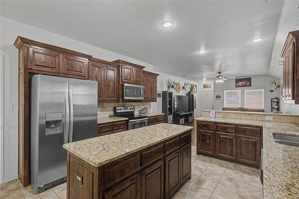208 Lovers Path Drive Springtown, TX 76082 - Photo 10 of 35 a kitchen with stainless steel appliances a sink stove and refrigerator