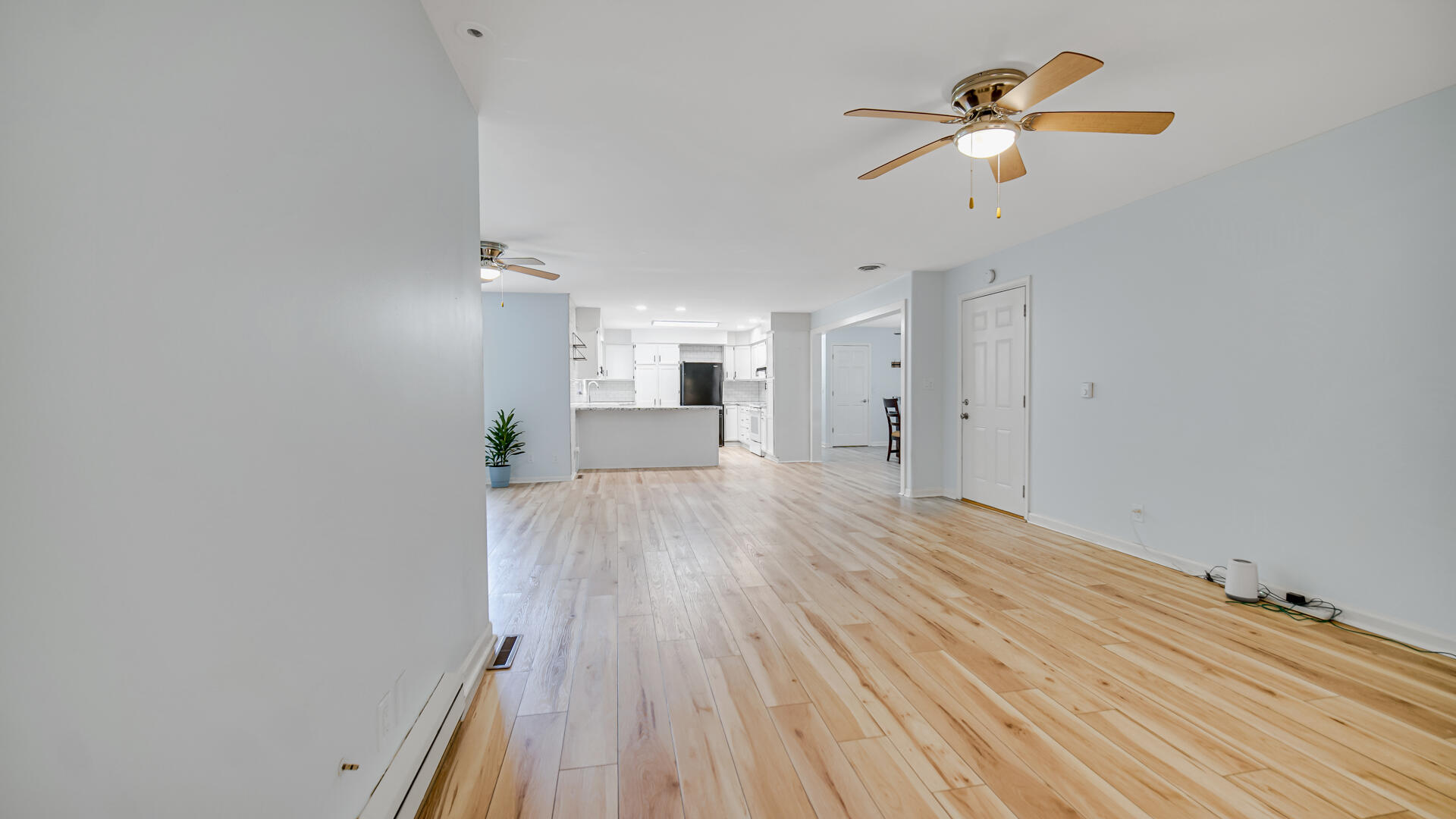 6717 State Rte 49 Rensselaer, IN 47978 - Photo 18 of 31 a view of a room with wooden floor and ceiling fan