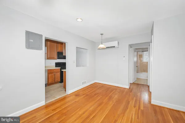 a view of empty room with wooden floor
