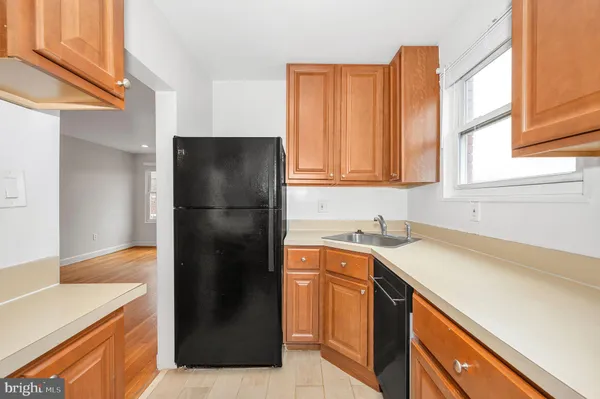 a kitchen with a refrigerator and a sink