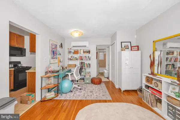 a living room with furniture and a book shelf