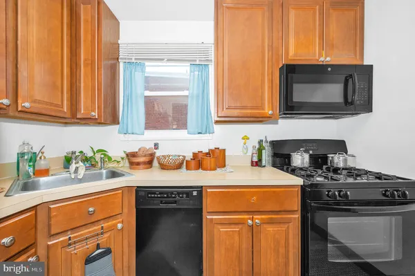 a kitchen with stove a sink and a microwave