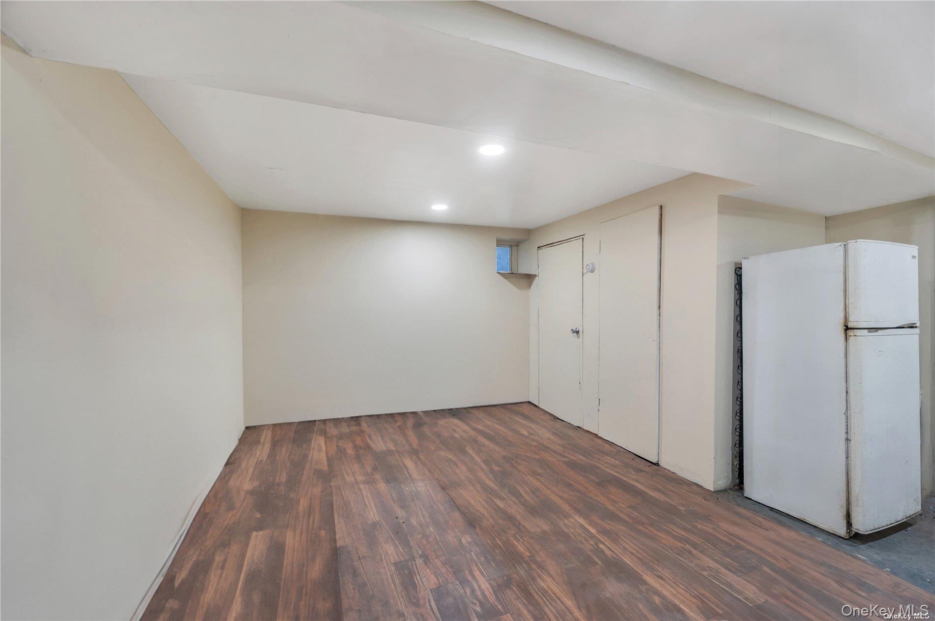 37-58 79th Street Queens, NY 11372 - Photo 22 of 28 a view of a room with wooden floor and a hallway