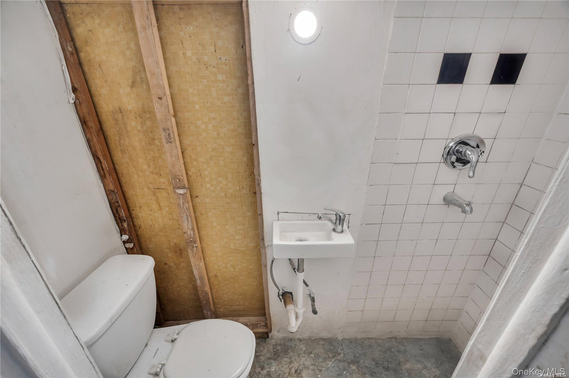 37-58 79th Street Queens, NY 11372 - Photo 24 of 28 a bathroom with a toilet and a shower