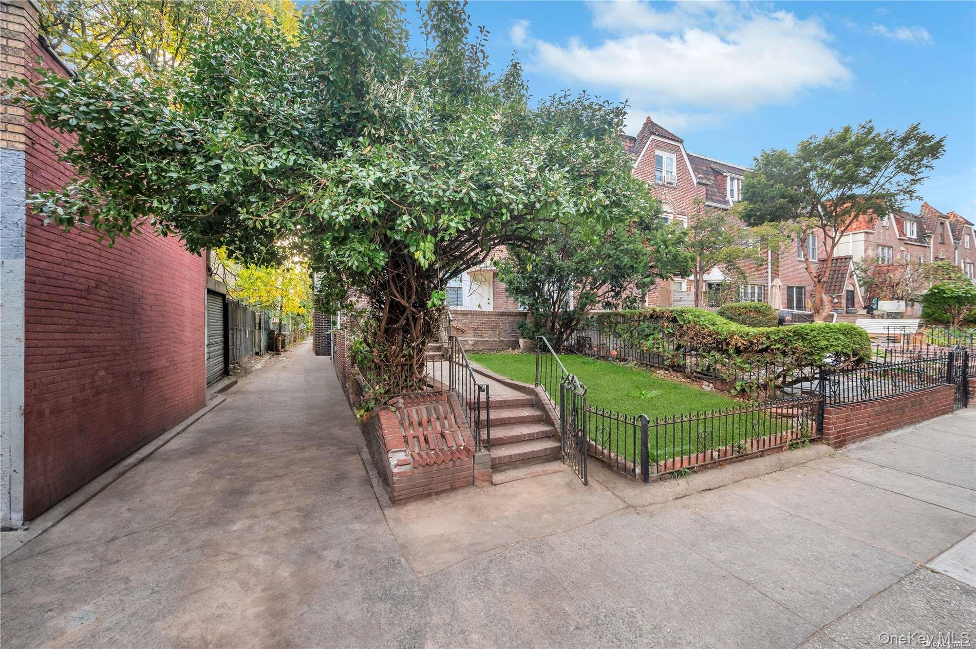 37-58 79th Street Queens, NY 11372 - Photo 4 of 28 a view of a garden with wooden fence