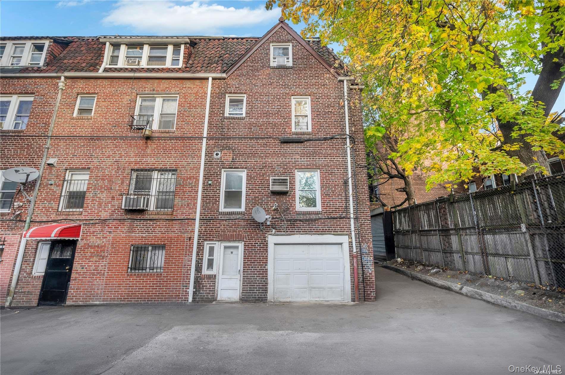 37-58 79th Street Queens, NY 11372 - Photo 6 of 28 a front view of a house with a garage