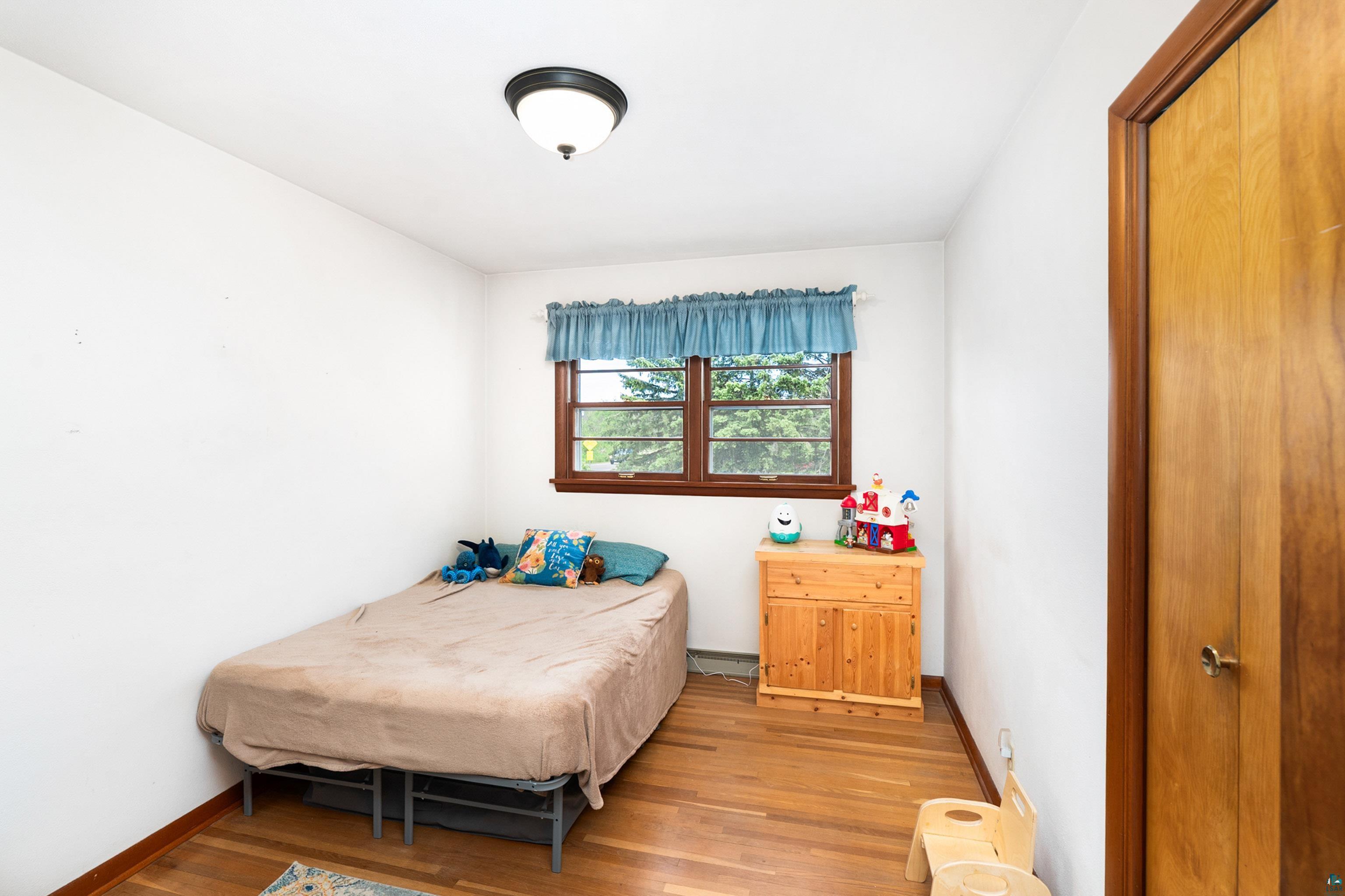 4808 Midway Road Duluth, MN 55811 - Photo 24 of 57 Room featuring wood-finish flooring and white painted walls