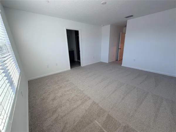 a front view of a house with garden and swimming pool