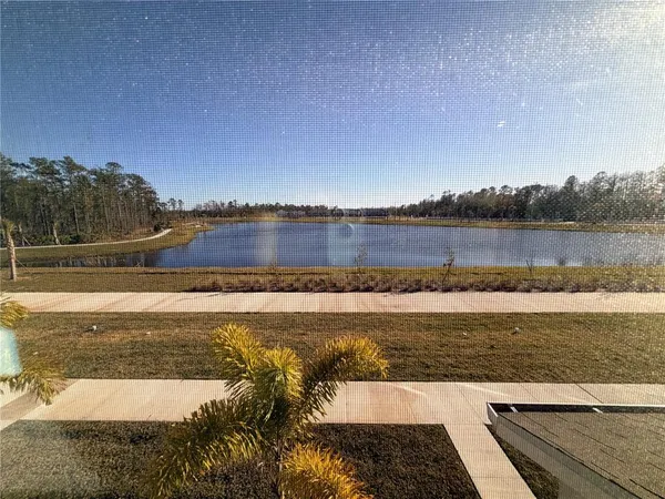 an aerial view of a swimming pool and lake view