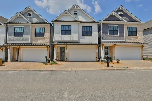 a front view of a house with a yard and a garage