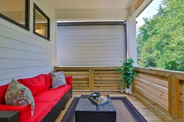 a view of deck with seating area and potted plants