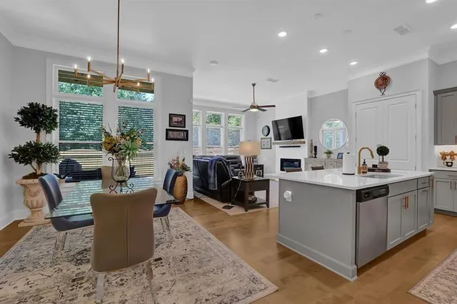 a living room with furniture a flat screen tv and kitchen view