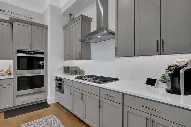 a kitchen with cabinets and steel appliances