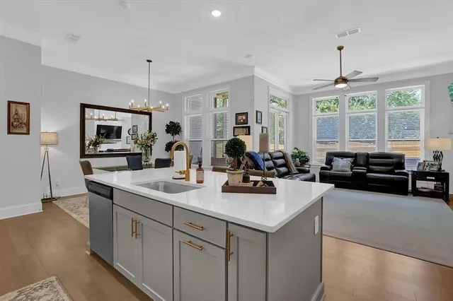 a view of a kitchen sink and living room