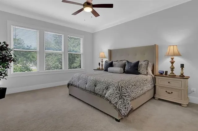 a bedroom with a large bed and a window