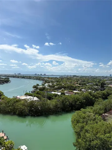 a view of a lake with houses in the back