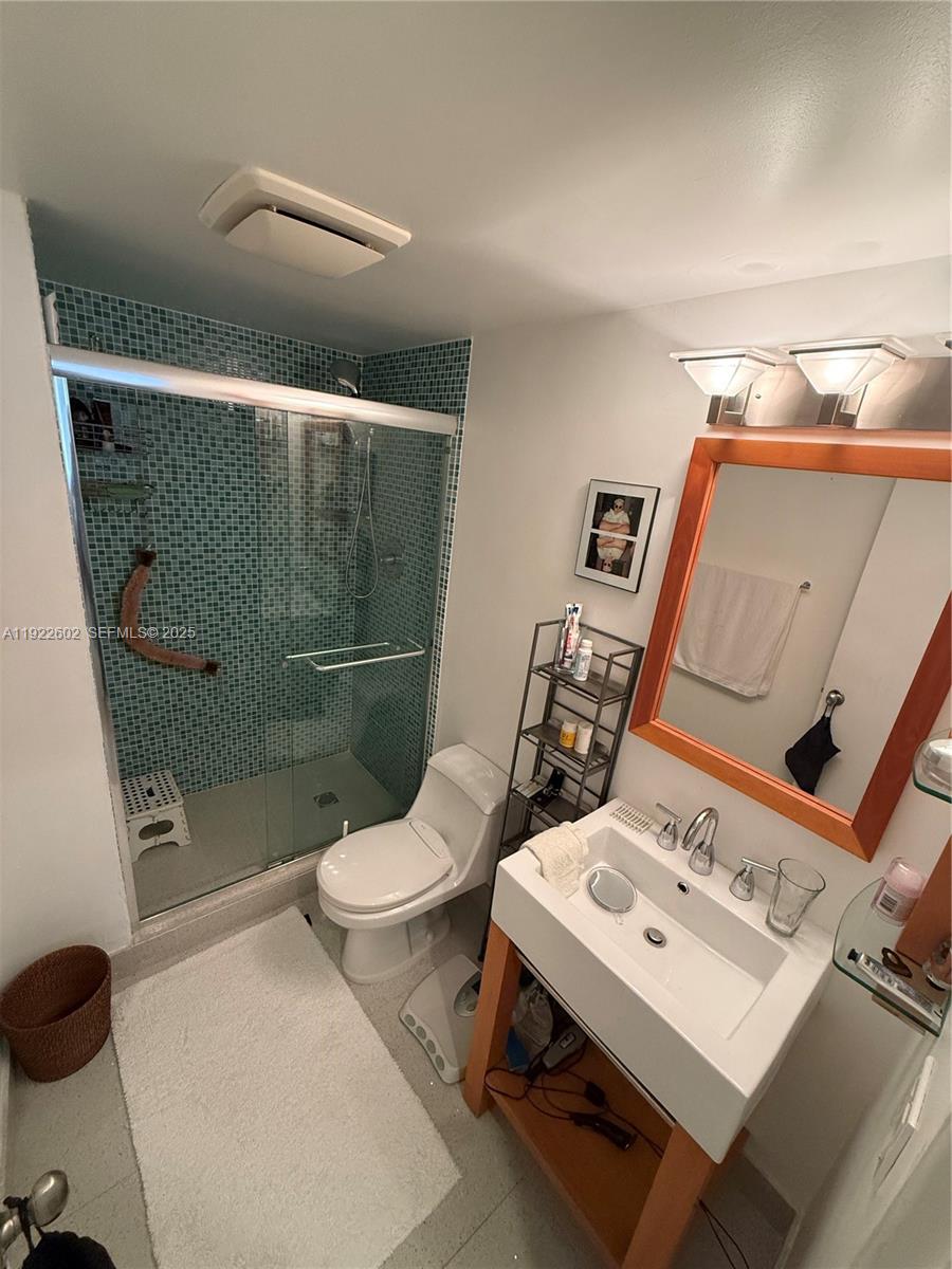 7441 Wayne Avenue, Unit 10E Miami Beach, FL 33141 - Photo 13 of 18 a white toilet sitting next to a bathroom sink