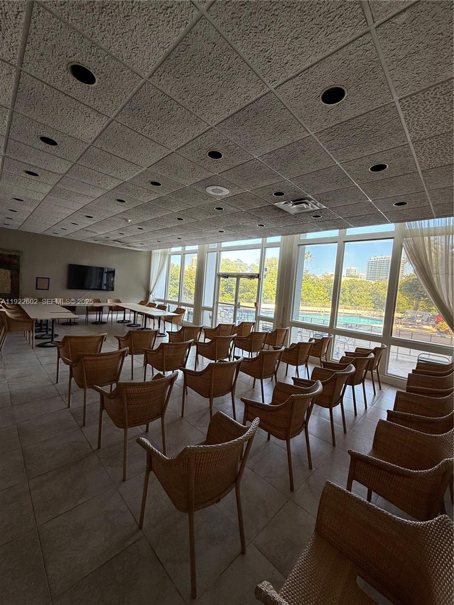 7441 Wayne Avenue, Unit 10E Miami Beach, FL 33141 - Photo 17 of 18 a group of people sitting at tables in a room