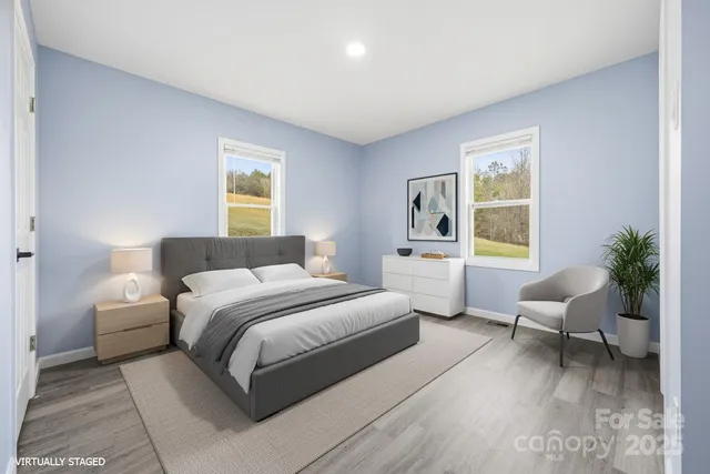 a bedroom with a bed and a large window