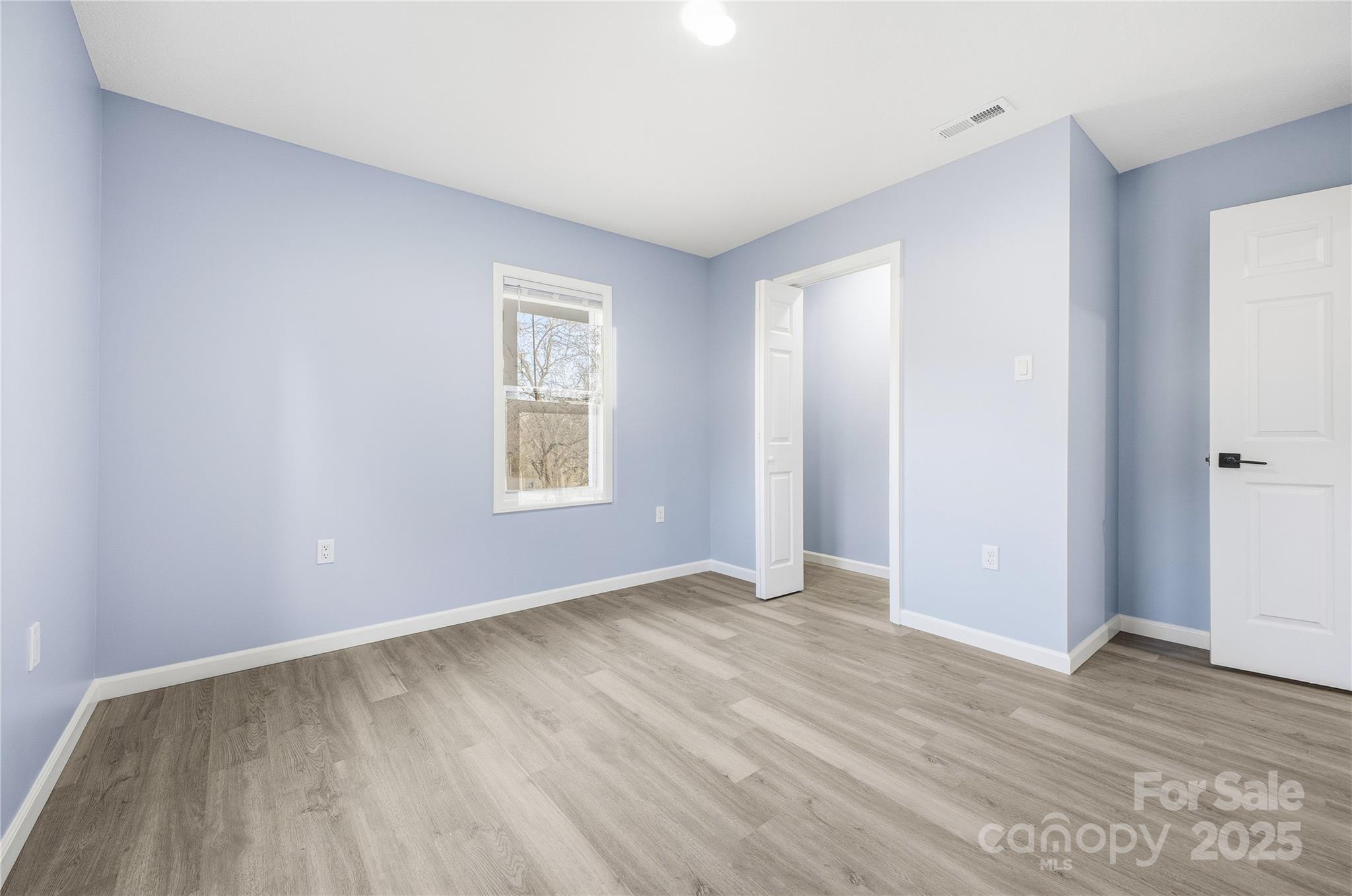 349 Gorman Bridge Road Asheville, NC 28806 - Photo 13 of 39 an empty room with wooden floor and windows