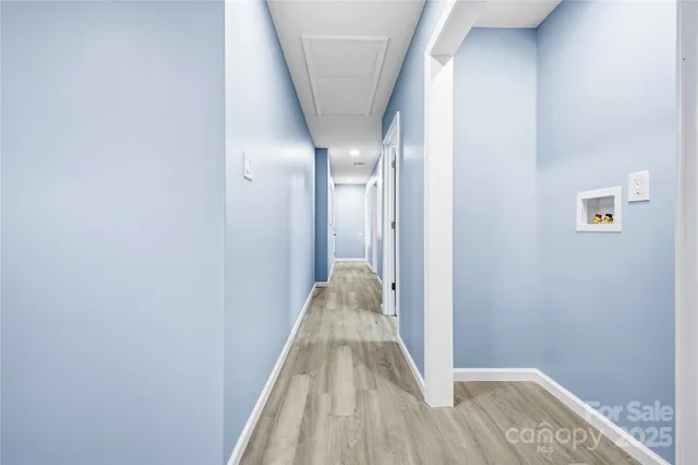 a view of a hallway with wooden floor