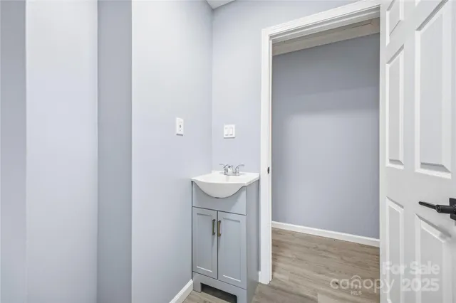a bathroom with a sink mirror and toilet