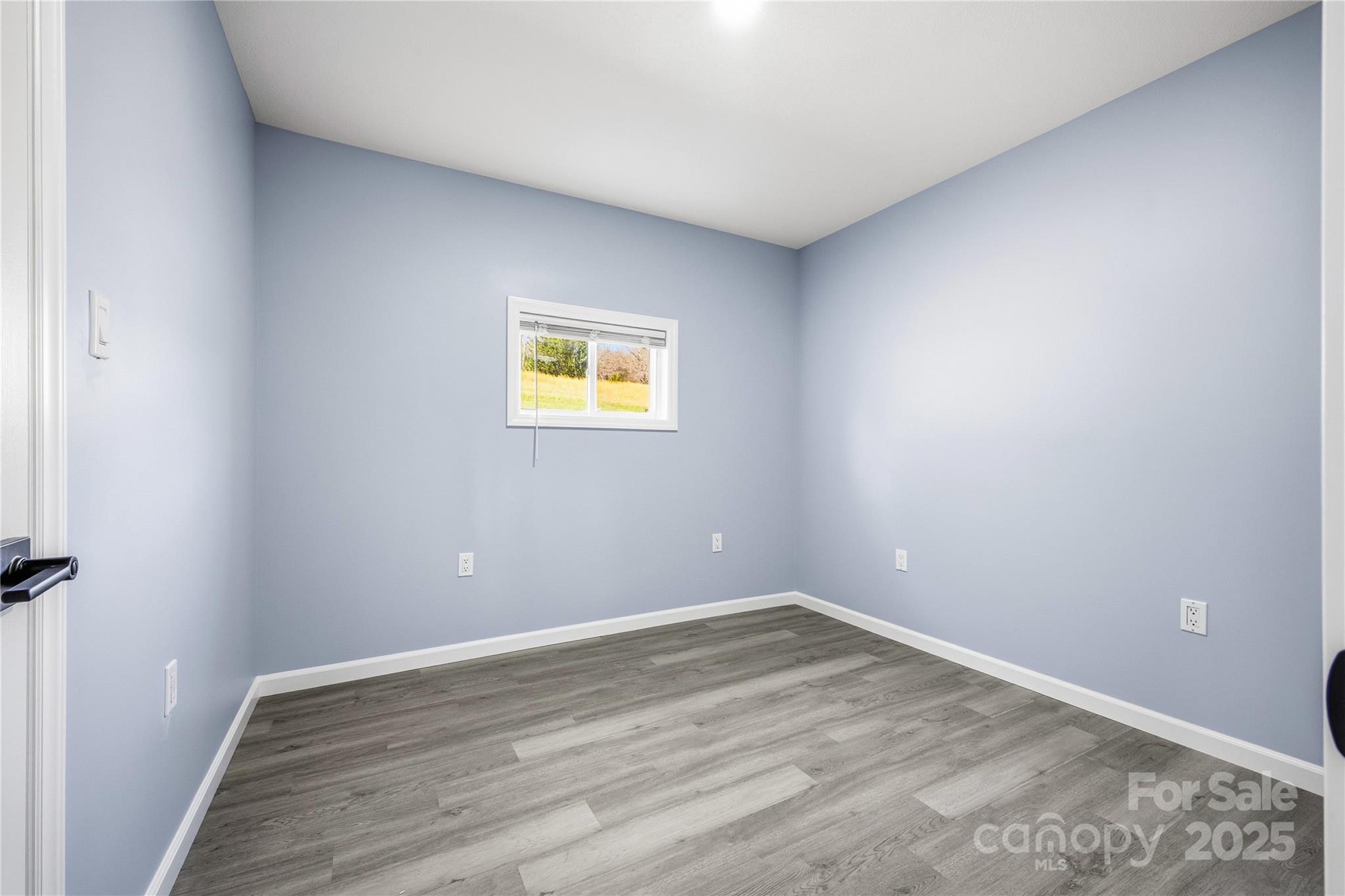 349 Gorman Bridge Road Asheville, NC 28806 - Photo 22 of 39 a view of an empty room with wooden floor and a window