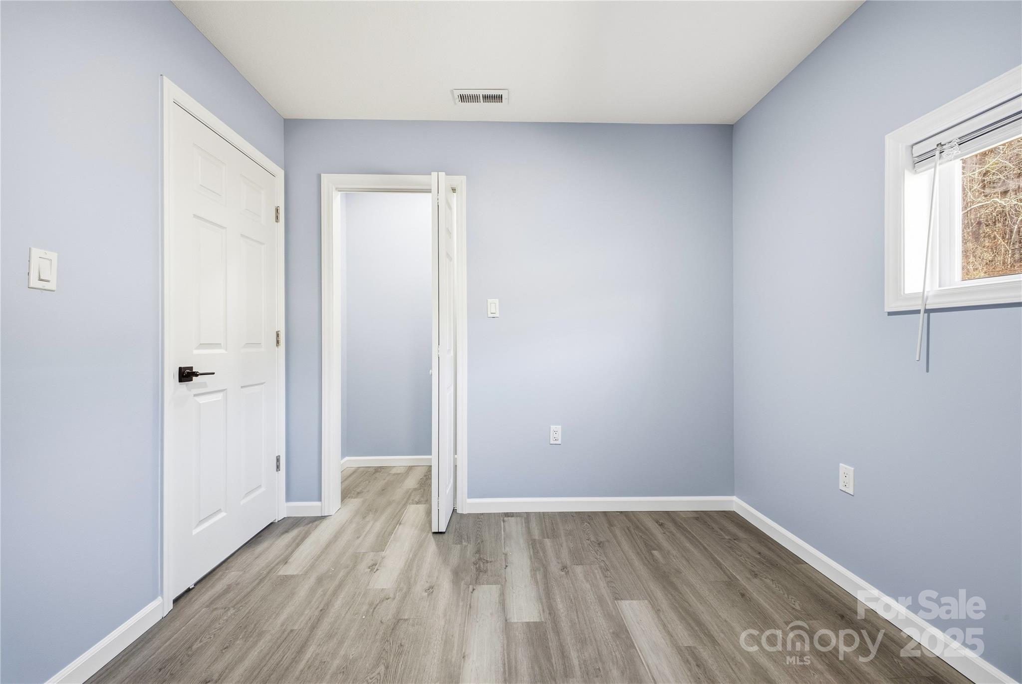 349 Gorman Bridge Road Asheville, NC 28806 - Photo 23 of 39 an empty room with wooden floor and windows