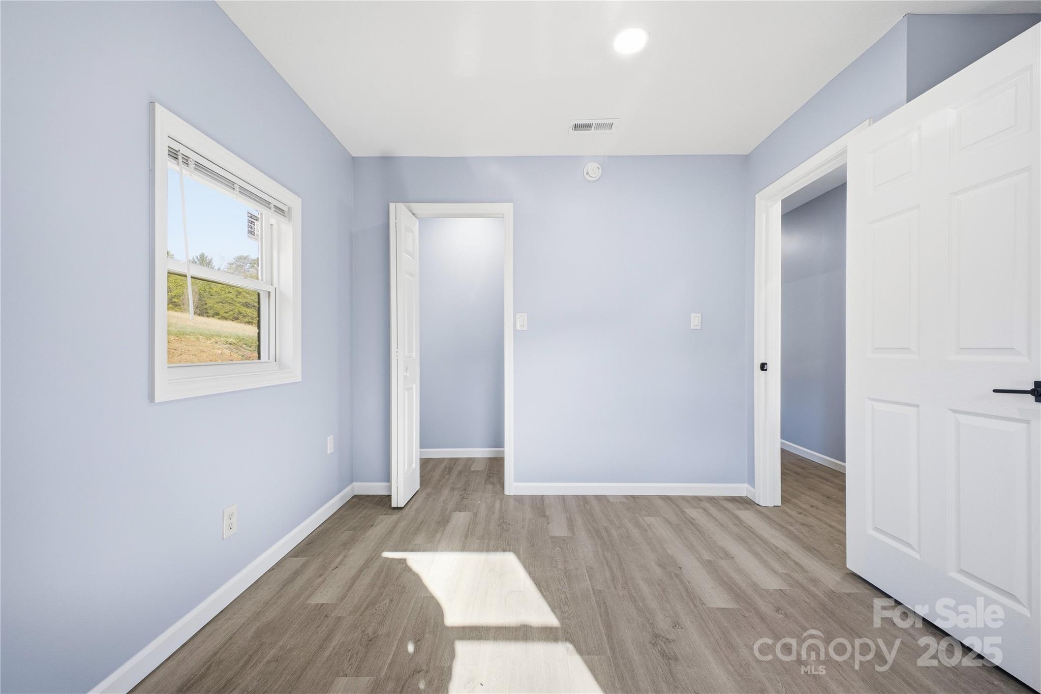 349 Gorman Bridge Road Asheville, NC 28806 - Photo 25 of 39 an empty room with wooden floor and window