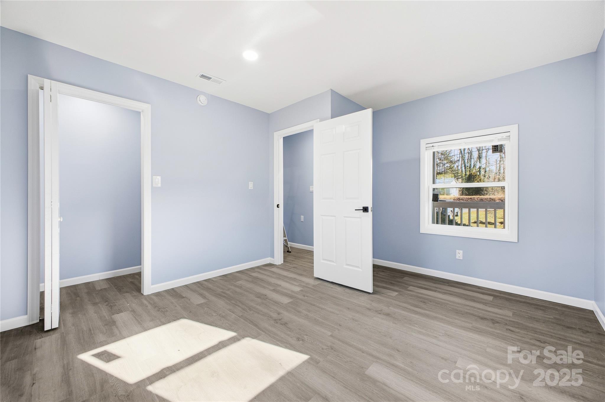 349 Gorman Bridge Road Asheville, NC 28806 - Photo 26 of 39 an empty room with wooden floor and windows