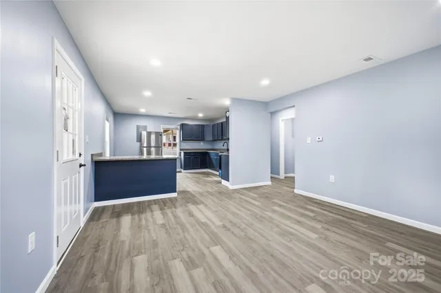 a view of kitchen cabinet and wooden floor