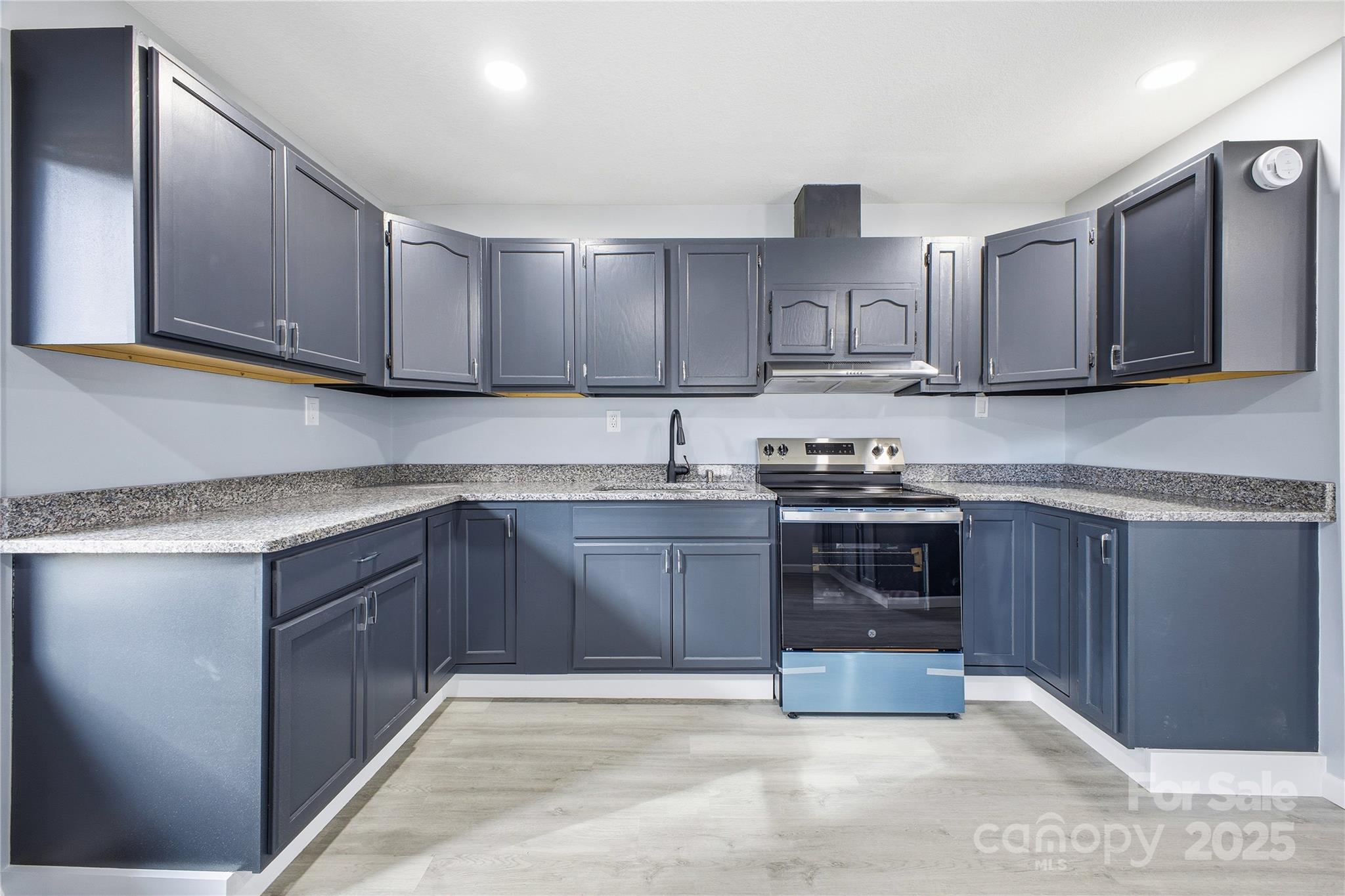 349 Gorman Bridge Road Asheville, NC 28806 - Photo 6 of 39 a kitchen with stainless steel appliances granite countertop a stove sink and cabinets