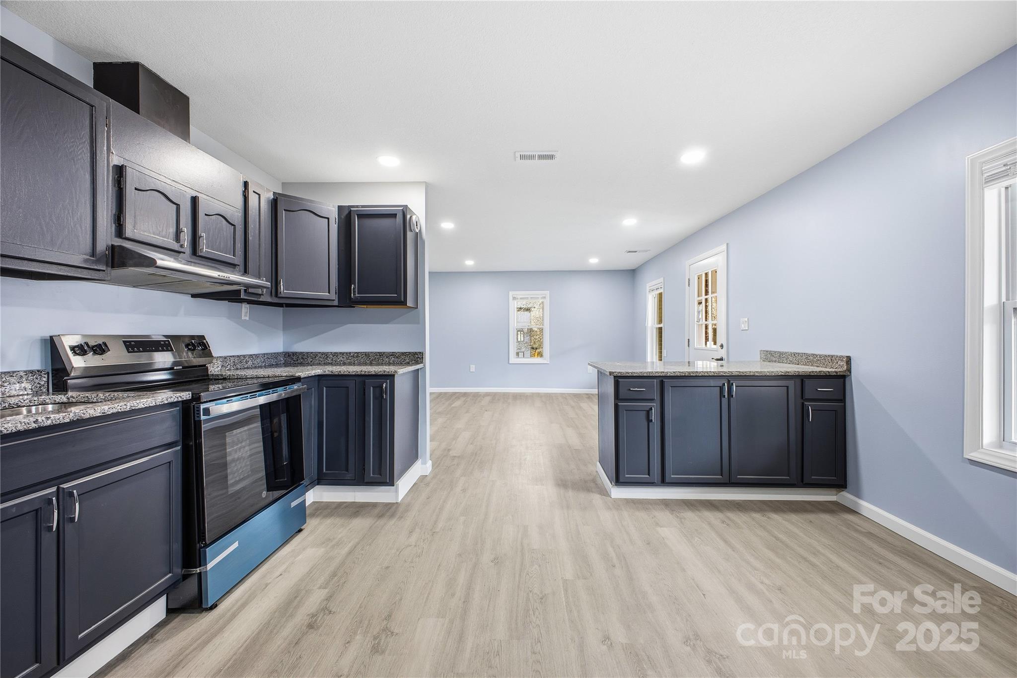 349 Gorman Bridge Road Asheville, NC 28806 - Photo 10 of 39 a kitchen with stainless steel appliances granite countertop a stove a sink and a refrigerator
