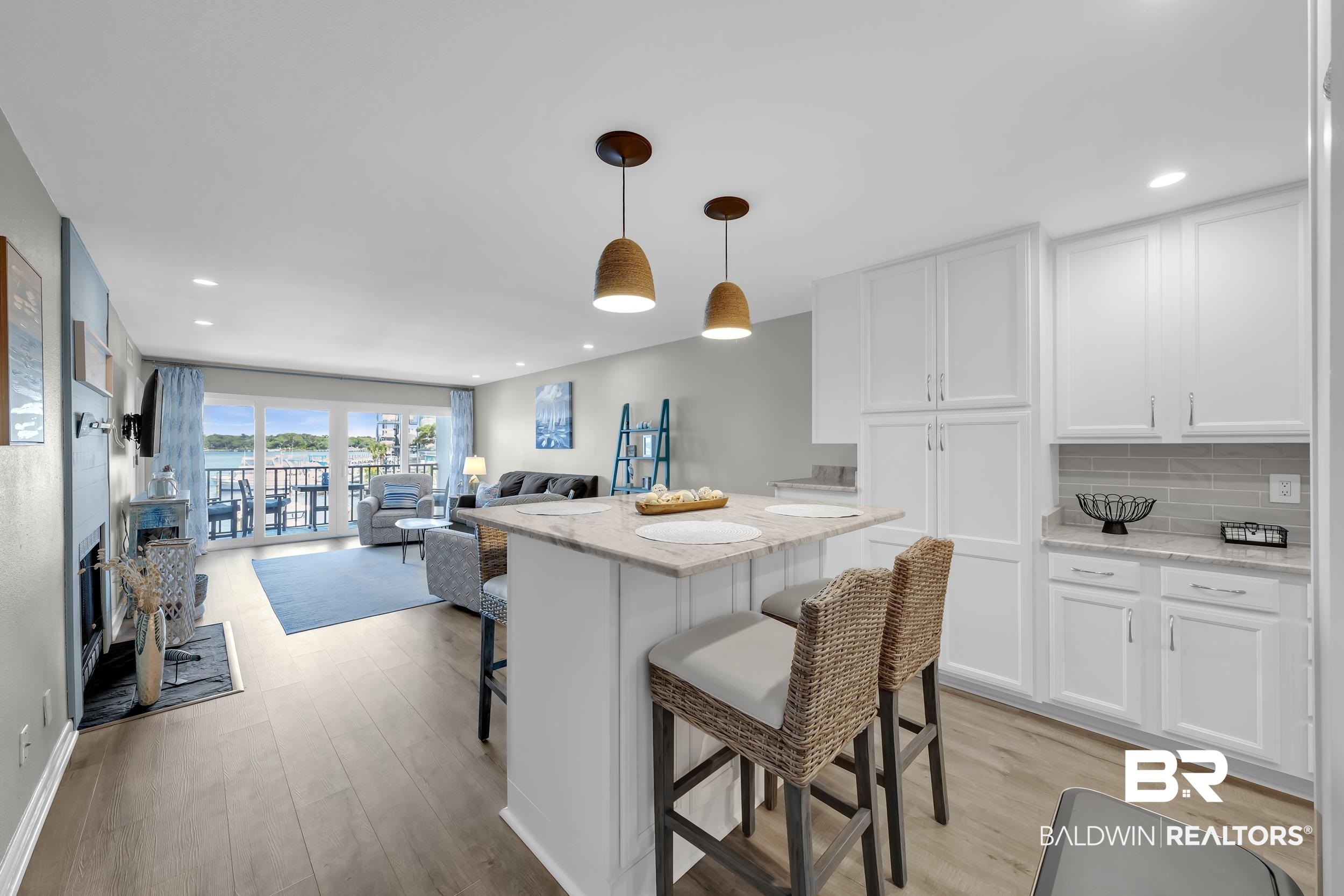 14100 River Road, Unit 211 Pensacola, FL 32507 - Photo 11 of 56 Open-concept living space featuring wood-finish flooring, recessed lighting, and a kitchen island with pendant lighting