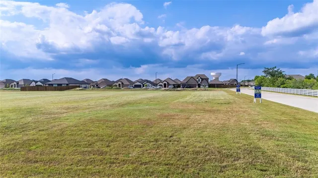 a view of a lake with houses in the back