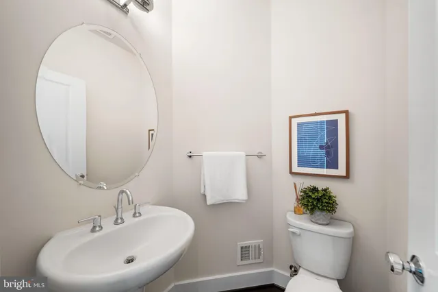a bathroom with a sink mirror and toilet
