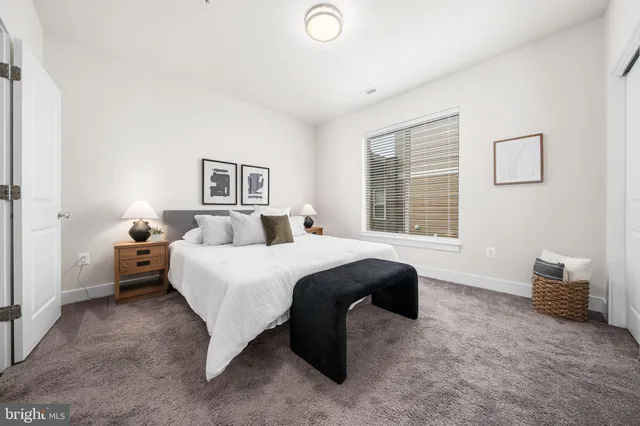 a bed room with a bed and a window