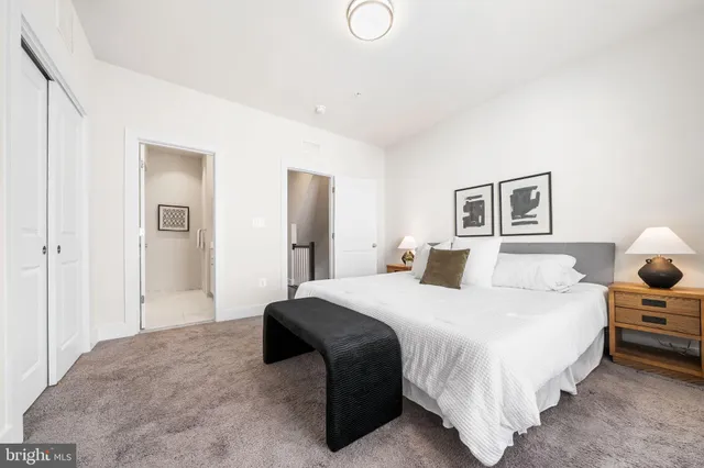 a bedroom with a bed and lamp