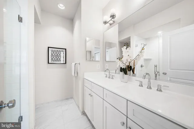 a bathroom with a sink a mirror and a shower