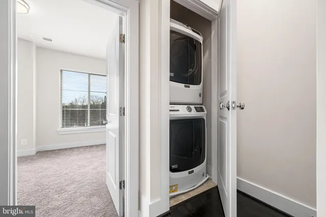 a view of a hallway with a washer and dryer