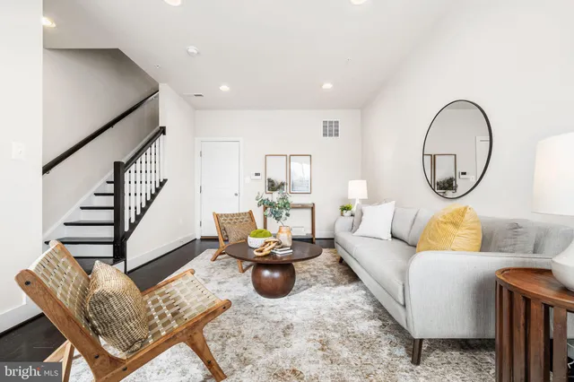 a living room with furniture and a mirror