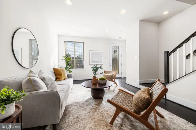 a living room with furniture and a mirror