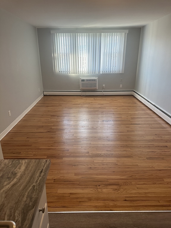 39 Carey Avenue, Unit 5 Watertown, MA 02472 - Photo 3 of 12 a view of wooden floor and windows in a room