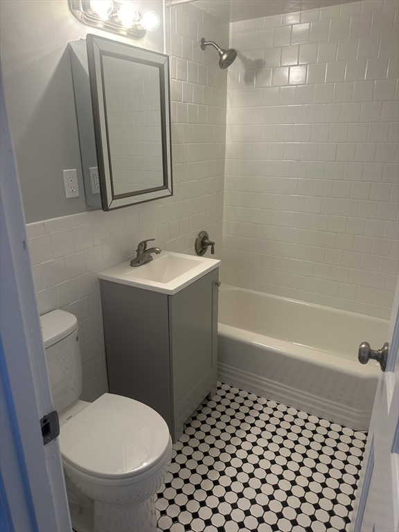 39 Carey Avenue, Unit 5 Watertown, MA 02472 - Photo 5 of 12 a bathroom with a sink a toilet and shower