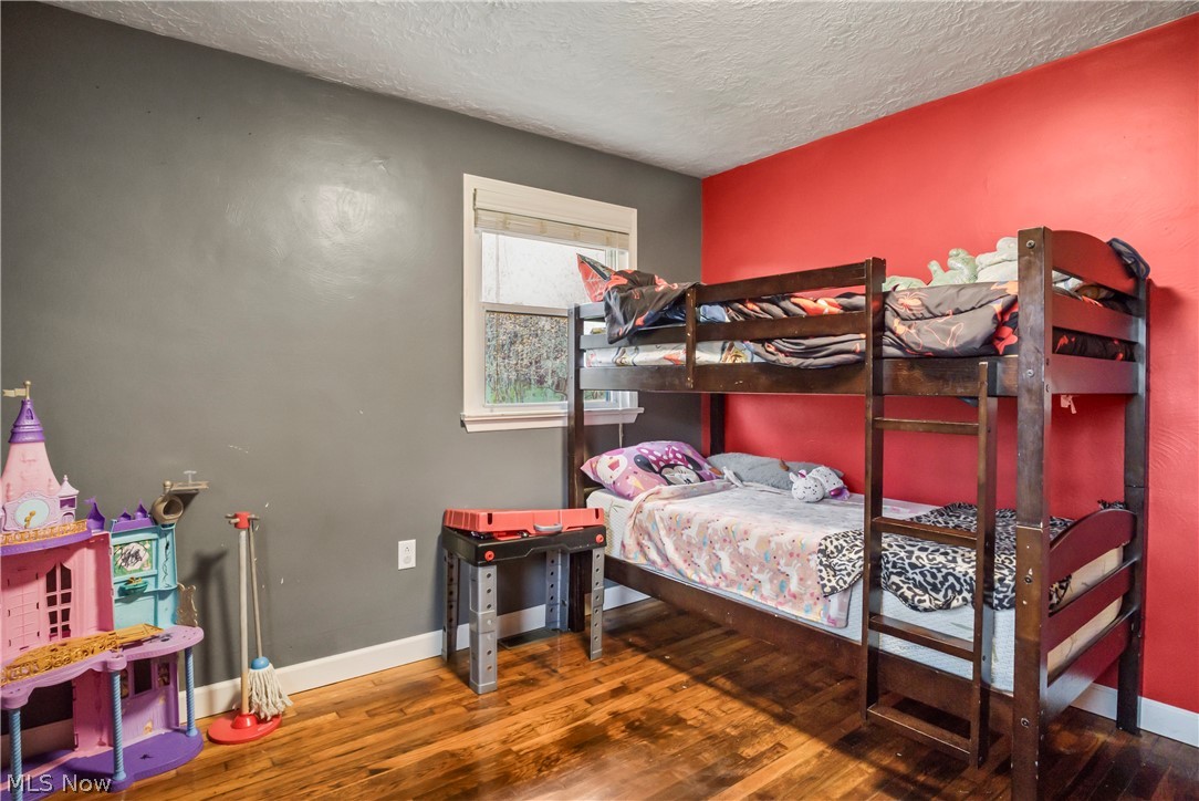 346 Amboy Road Conneaut, OH 44030 - Photo 24 of 41 Bedroom featuring wood-type flooring and a textured ceiling