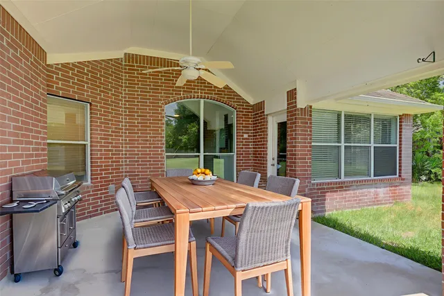 a bedroom with a large bed and a flat tv screen on dresser