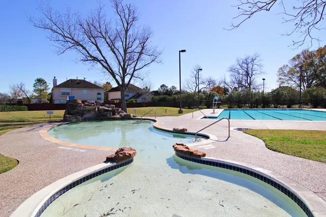 a view of swimming pool with outdoor seating and plants